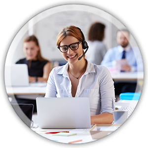 office woman at a desk working weaaring a headset smiling